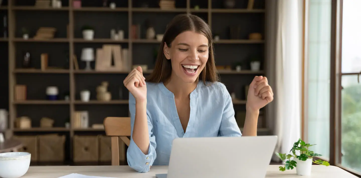 Happy Woman Using RPG API Express on Laptop